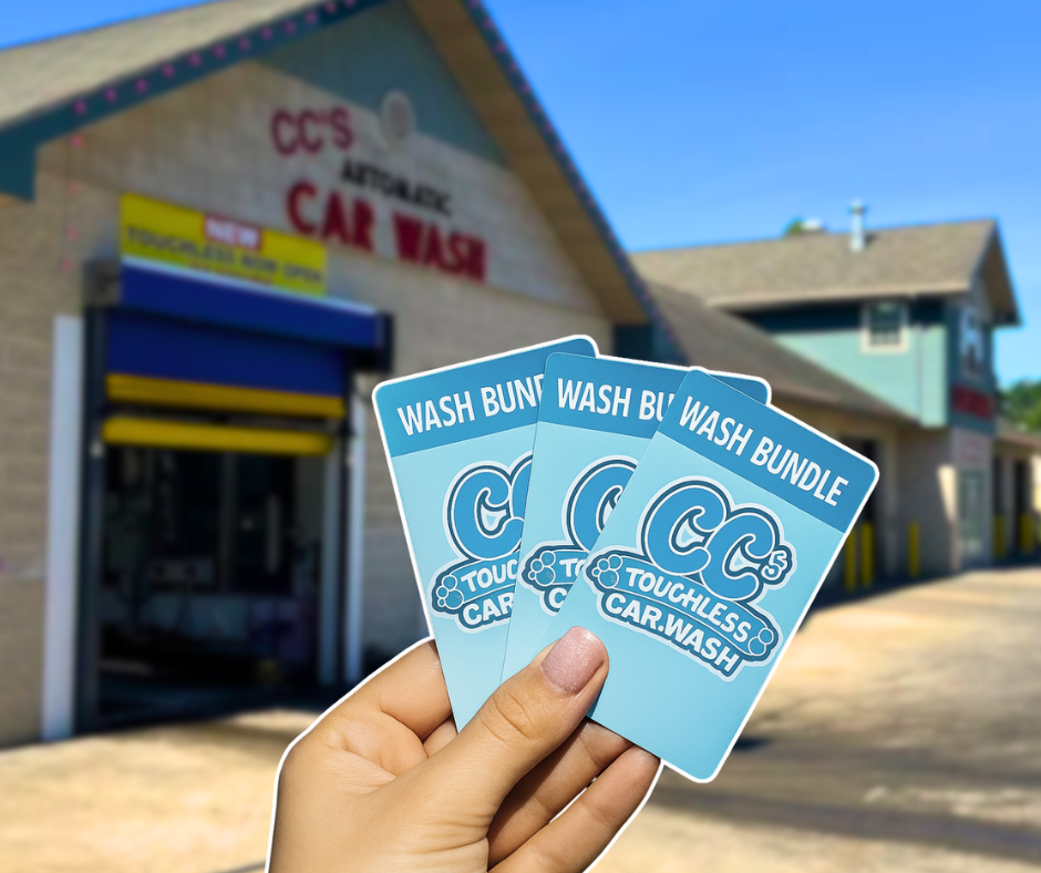 A hand holds three blue CC’s Touchless Car Wash bundle cards in front of the corresponding car wash building.