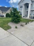 A large white house with a lot of grass and trees in front of it