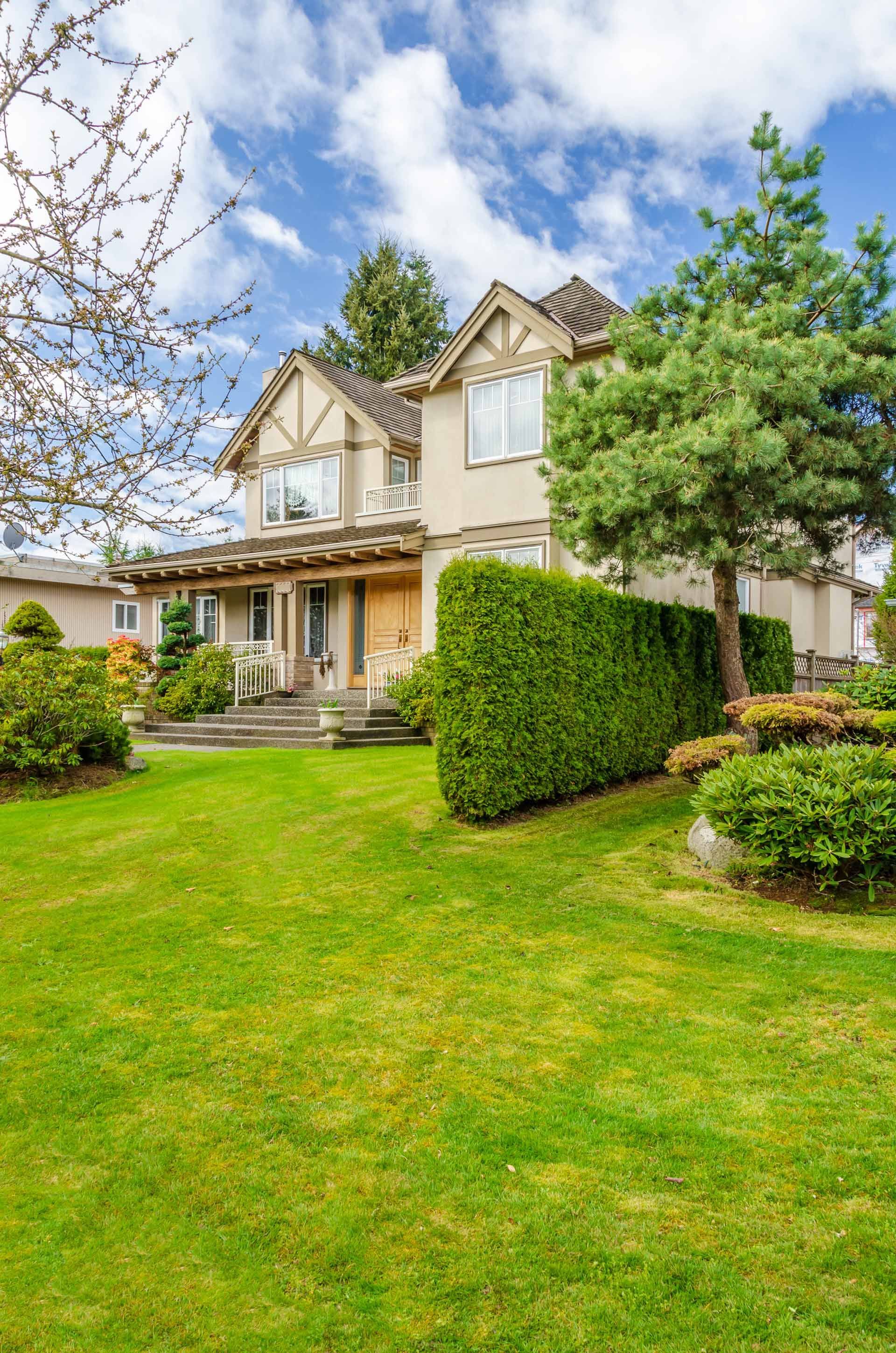A large house with a lush green lawn in front of it