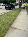 A car is parked on the side of the road next to a sidewalk