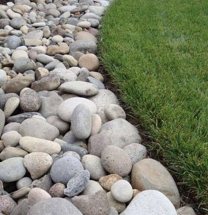Pebble bed border beside a green lawn edge