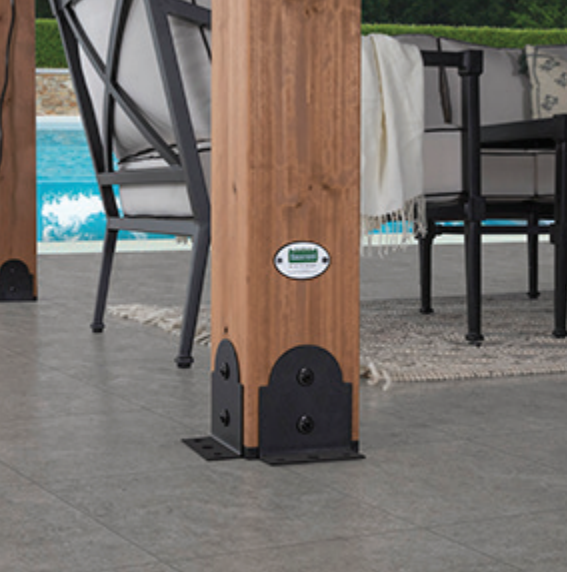 Wooden patio table post with metal base on a poolside deck, with chairs in the background.