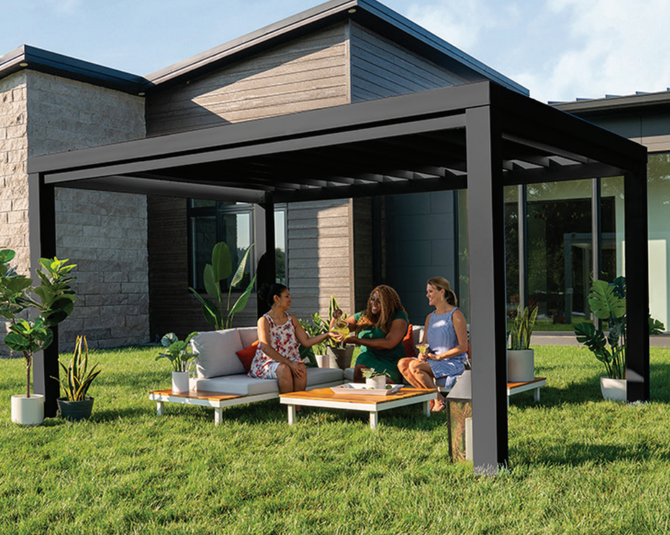 Three people chatting on a patio under a modern pergola beside a contemporary house