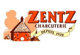 Logo de Zentz Charcuterie avec texte rouge, illustration d'une petite maison et inscription « Depuis 1920 » sur un ruban