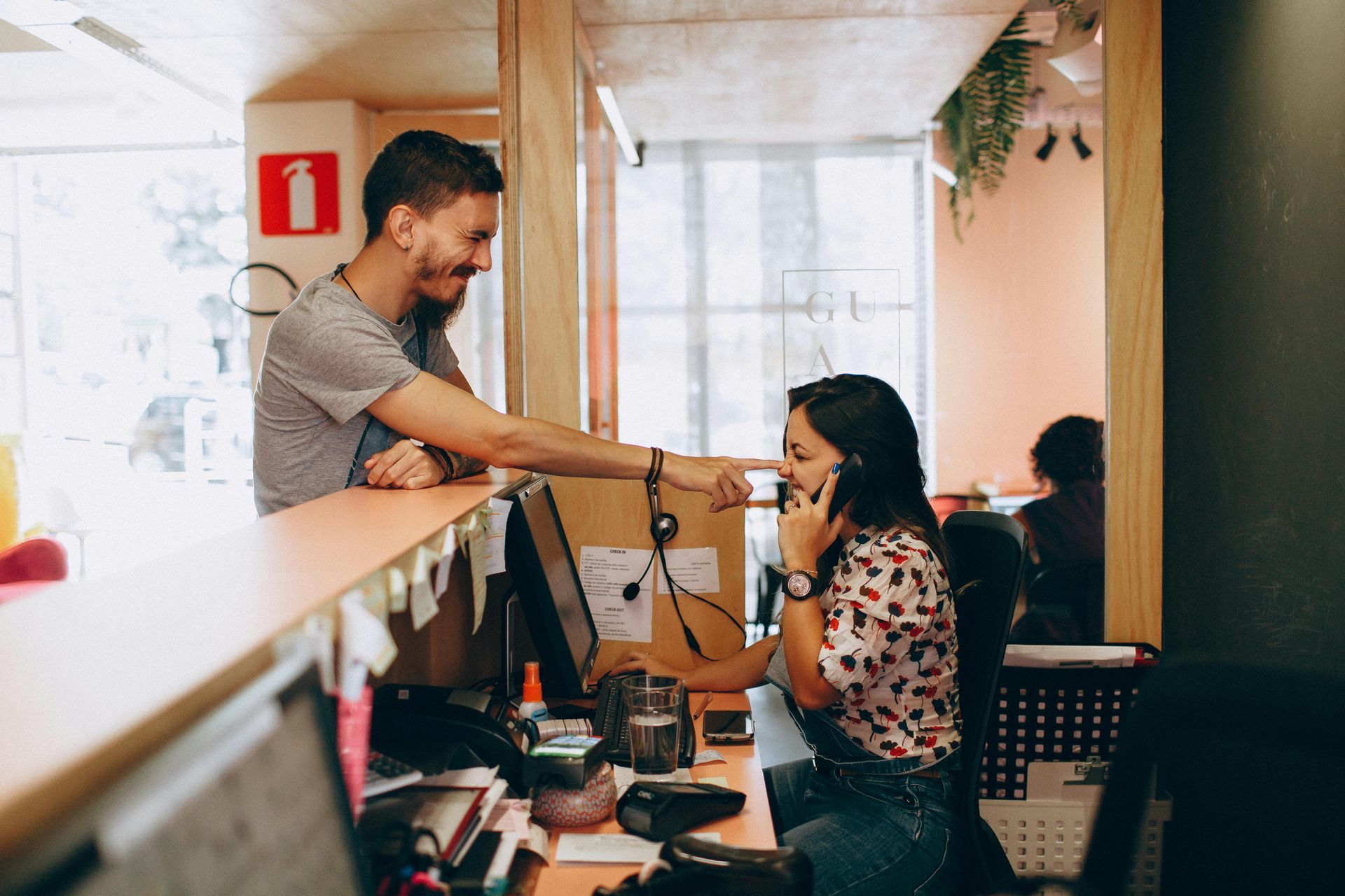 Barista handing a coffee to a customer at a café counter