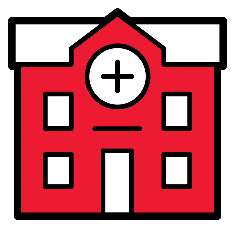 Bâtiment hospitalier rouge avec une croix blanche sur un panneau circulaire au-dessus de l'entrée.