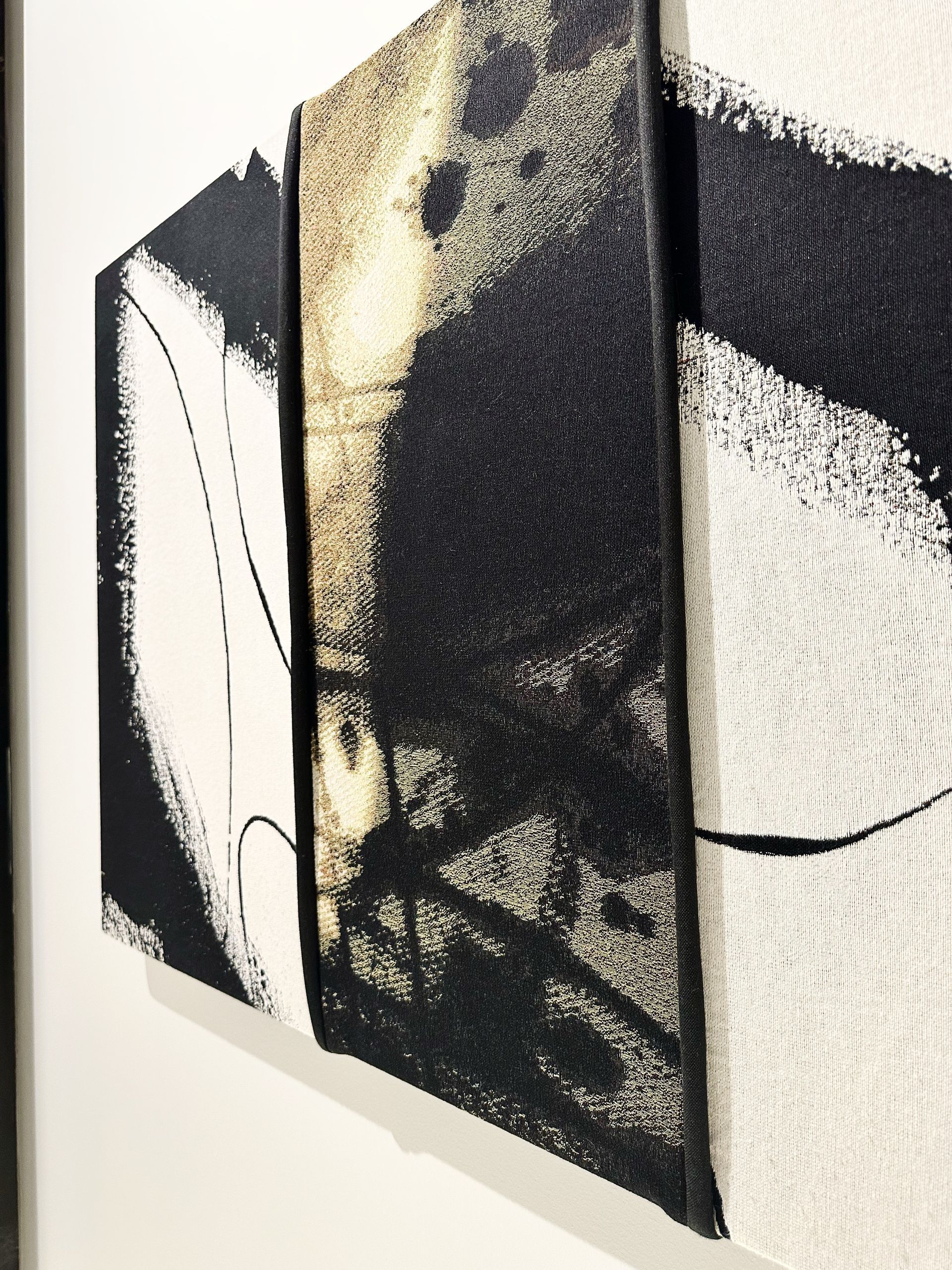 A black and white painting on a white wall