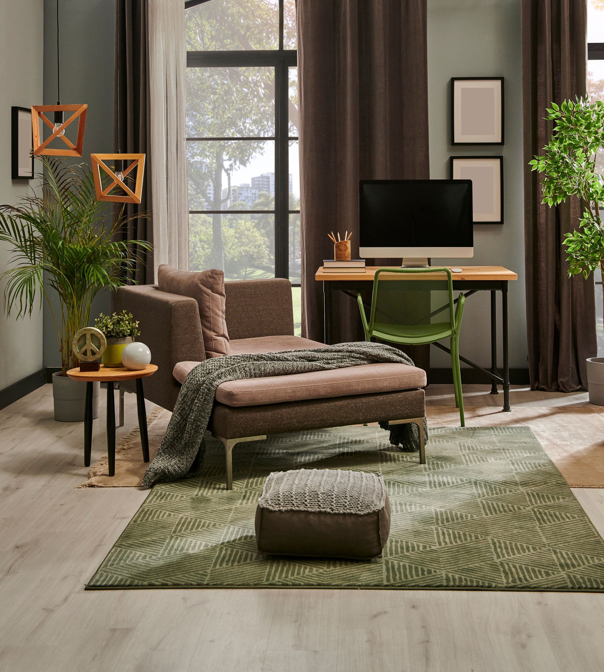 Cozy living room with chaise lounge, desk, plant, and green rug by a sunlit window Cozy living room with chaise lounge, desk, plant, and green rug by a sunlit window