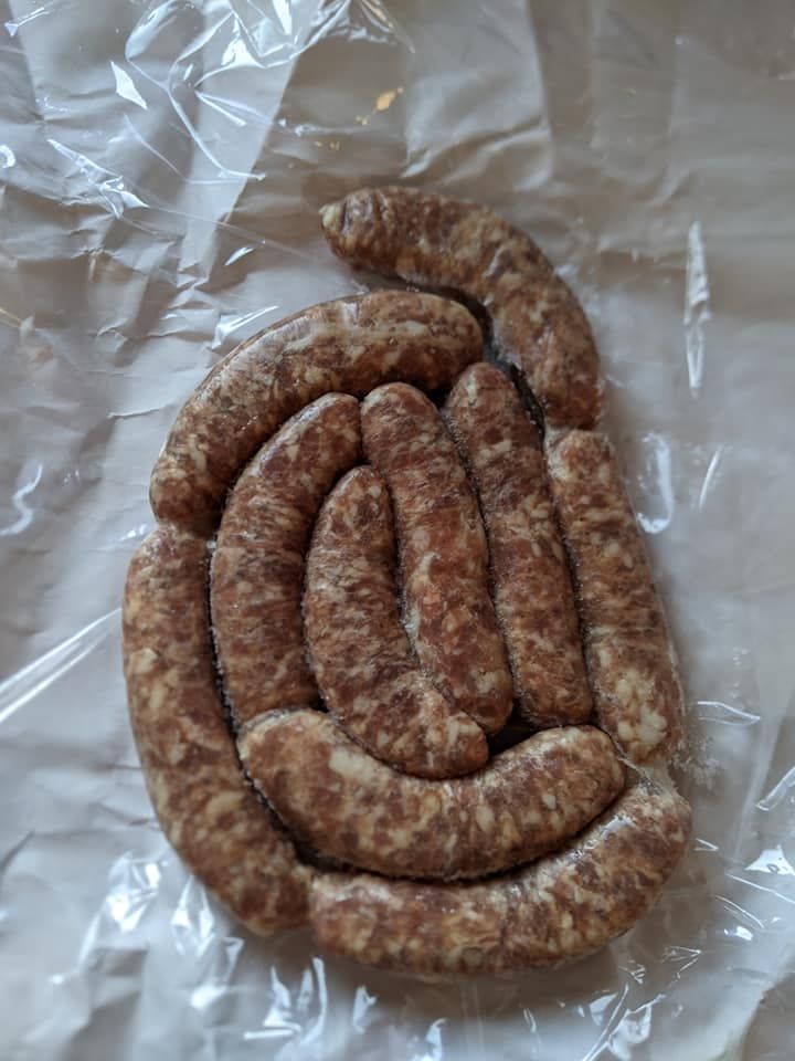 Coiled raw sausage links on aluminum foil