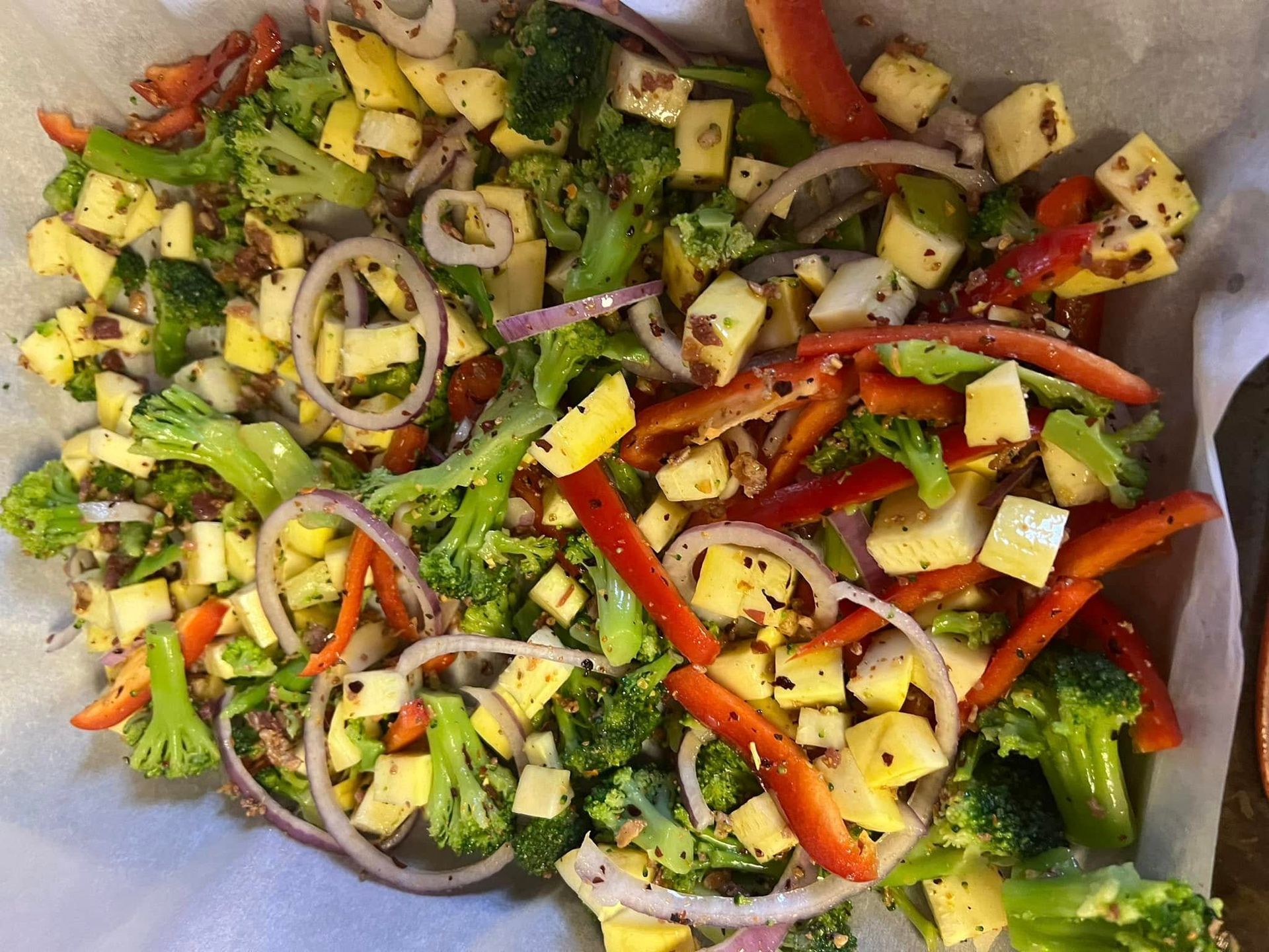 Roasted mixed vegetables with broccoli, bell peppers, onions, and zucchini on a baking tray