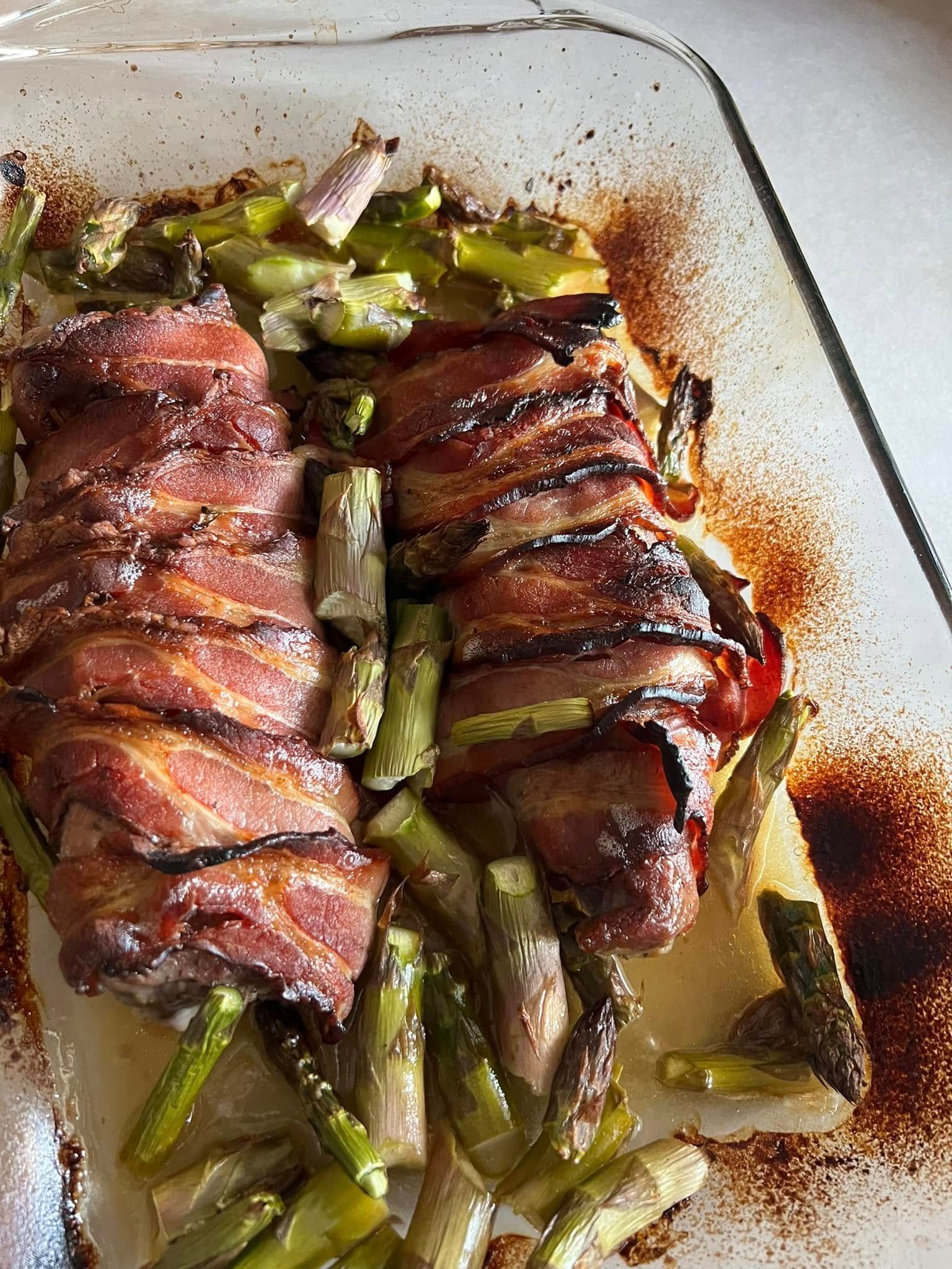 Bacon-wrapped asparagus and roasted green beans in a glass baking dish
