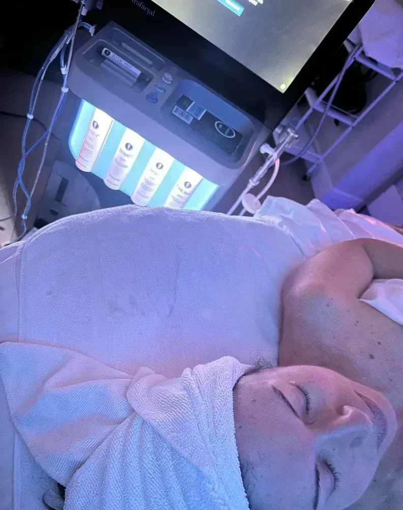 Client receiving a HydraFacial with LED therapy and booster serums at Spa La La Tampa