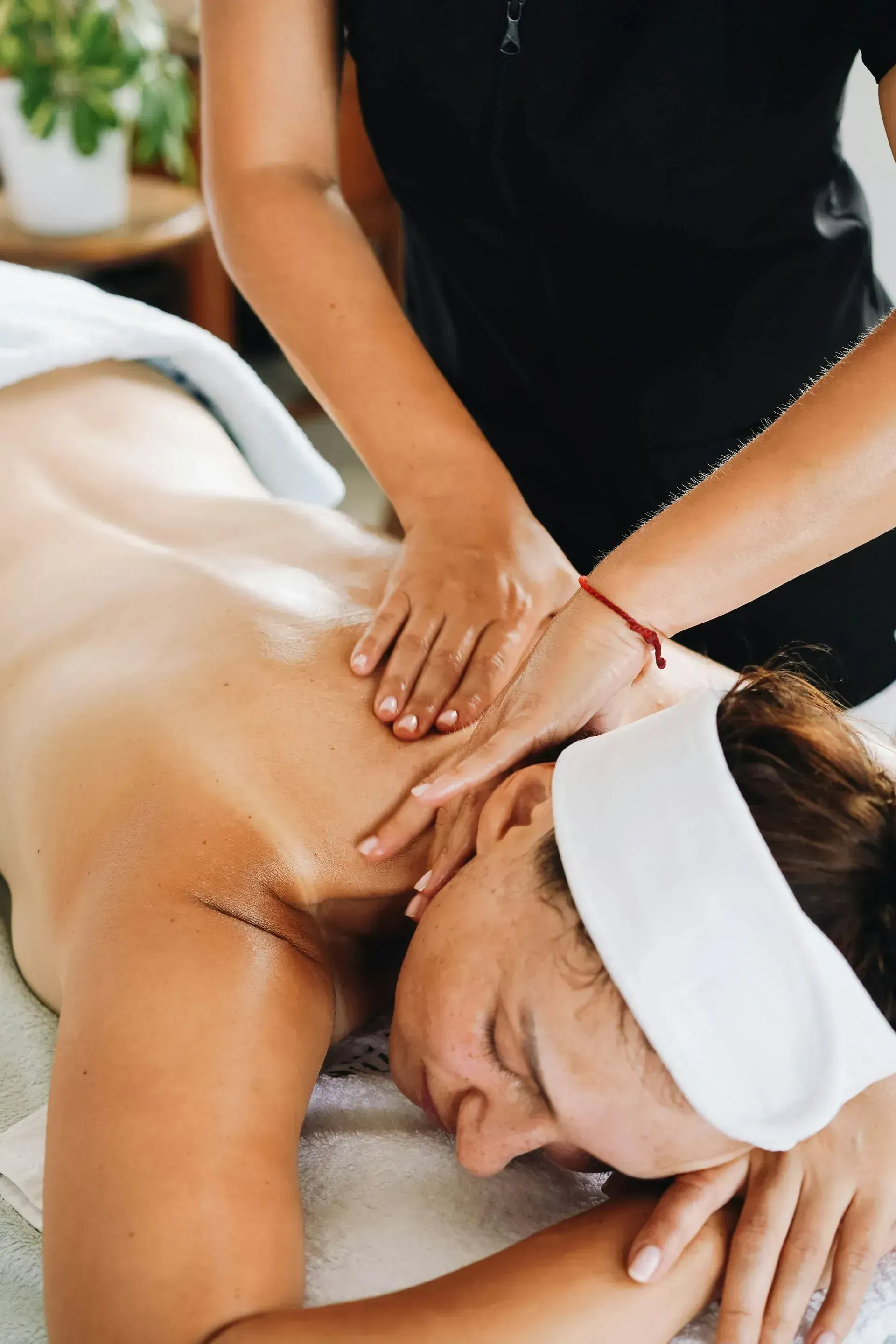 Person receiving a back massage at a spa. Person receiving a back massage at a spa.