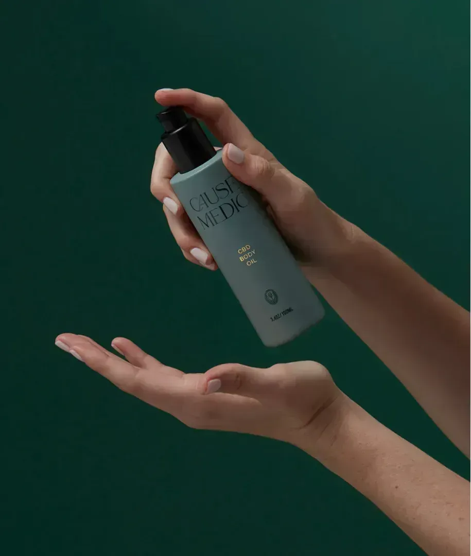 Hands dispensing product from a teal bottle with black pump. Hands dispensing product from a teal bottle with black pump.