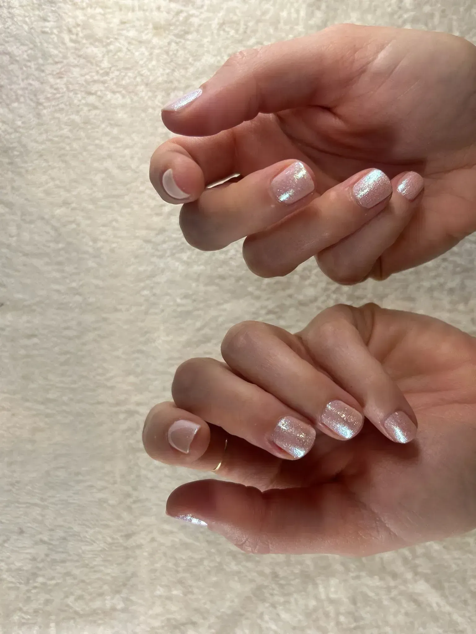 Hands with iridescent nail polish. Hands with iridescent nail polish.