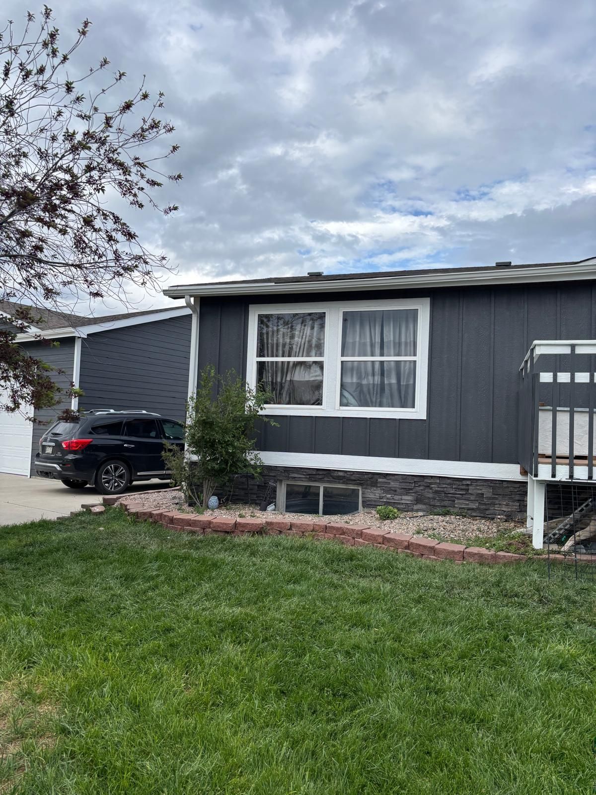 A house with two garage doors and a gutter on the side of it