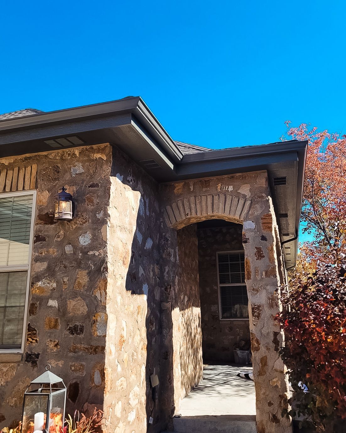A stone house with a blue sky in the background