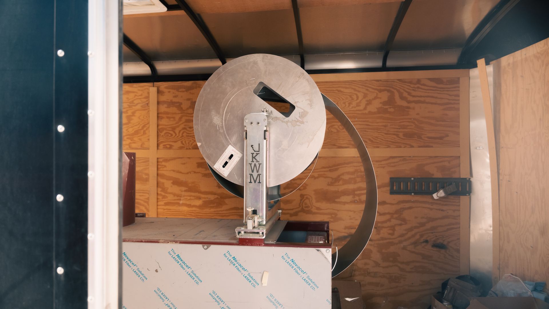 A large metal object is sitting inside of a trailer.