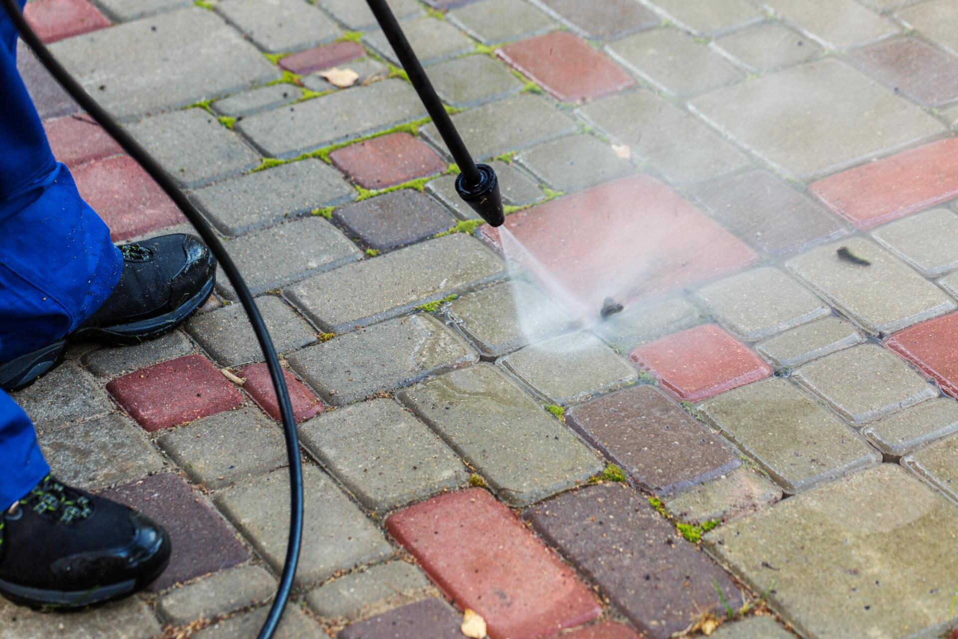 Cleaning weeds between cracks in brick patio