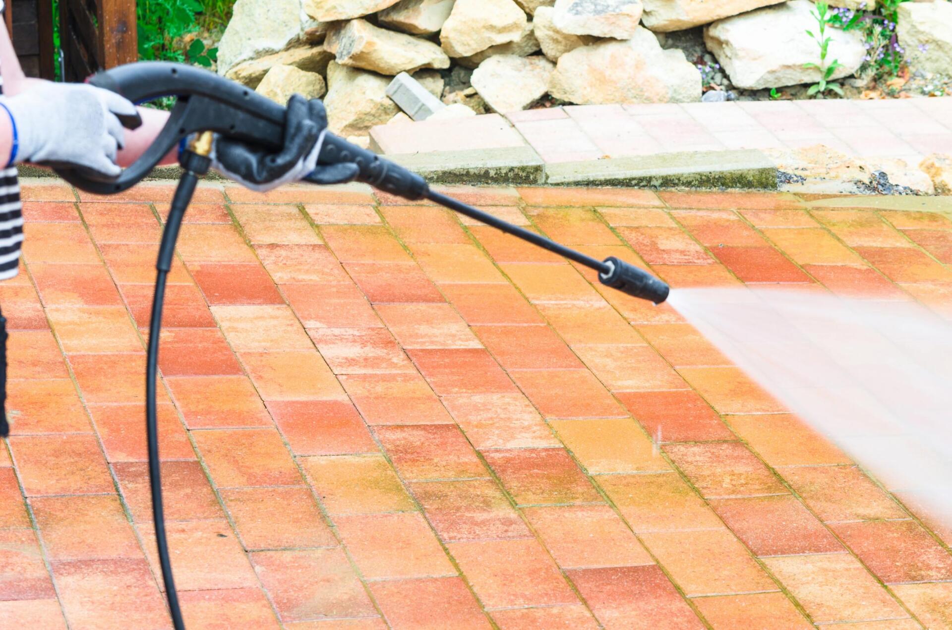 Contractor cleaning brick patio