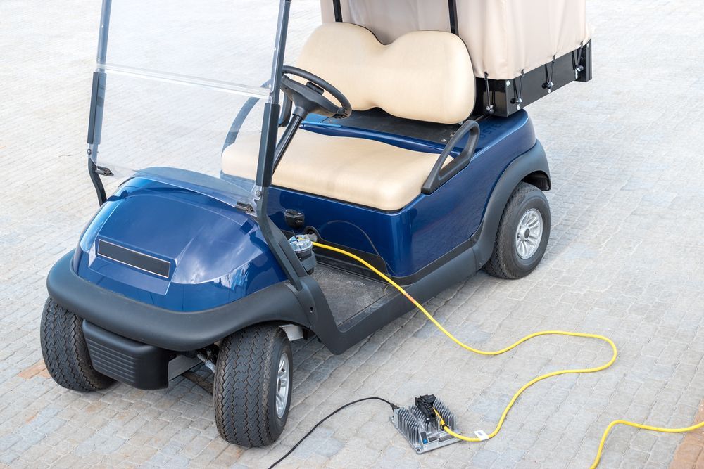 Blue Golf Cart Charging on a Concrete Surface — Orange Auto Electrics in Orange, NSW