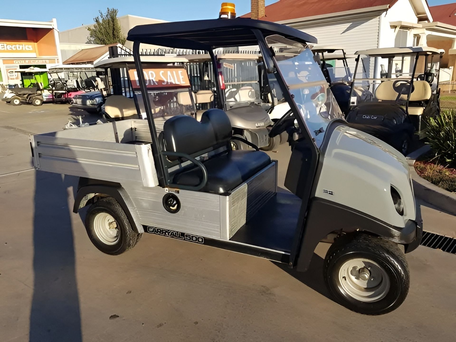 Grey Utility Golf Cart With Black Roof and Flashing Light, Parked Outside — Orange Auto Electrics in Orange, NSW