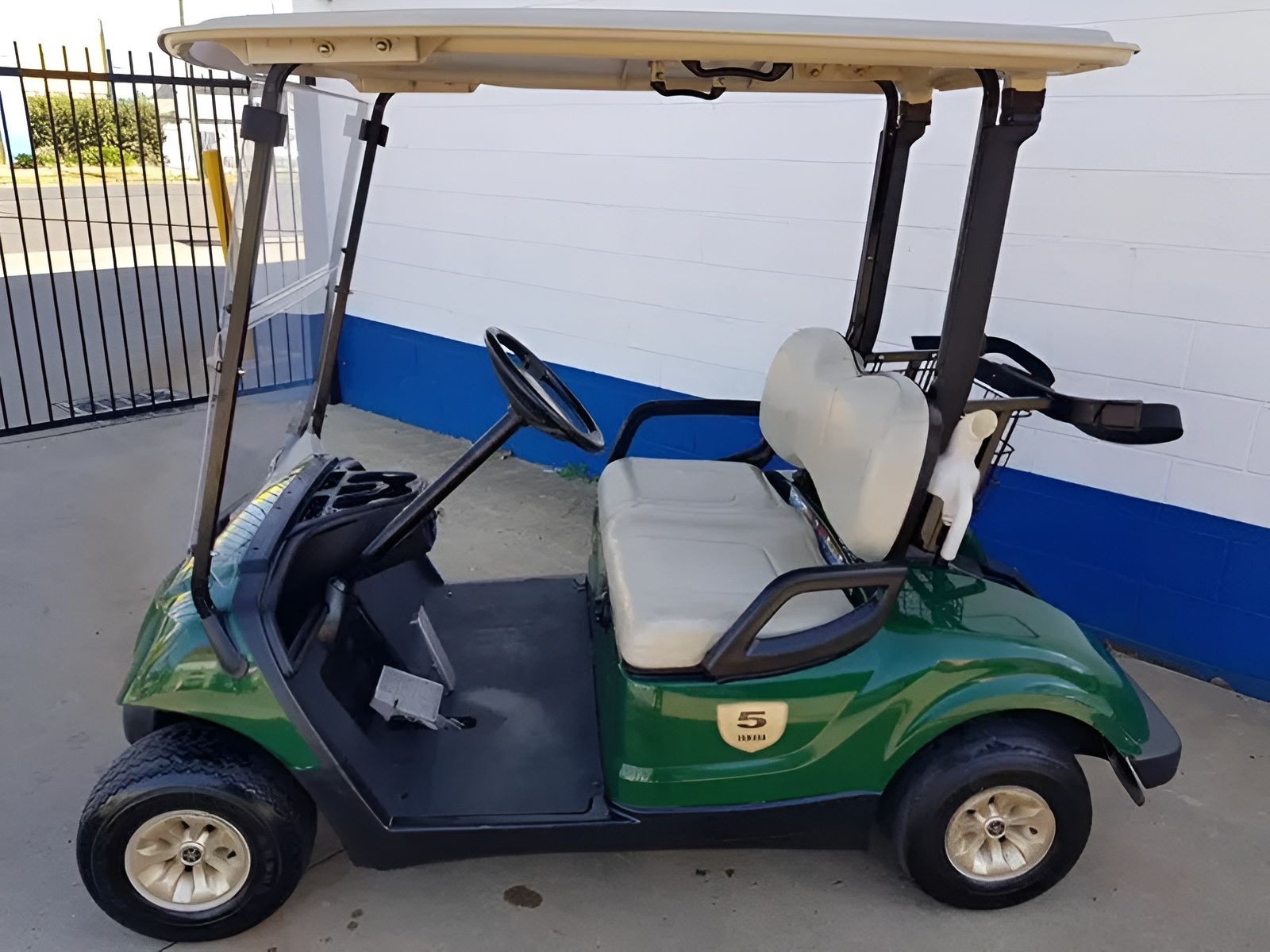 Green Golf Cart With Beige Roof and Seats Parked Outdoors — Orange Auto Electrics in Orange, NSW