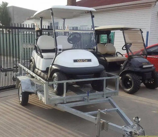 White Golf Cart on a Trailer, Next to a Black Golf Cart — Orange Auto Electrics in Orange, NSW