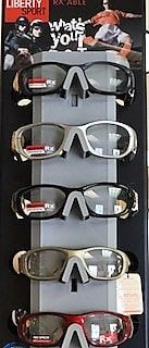 A display of sunglasses on a stand in a store.