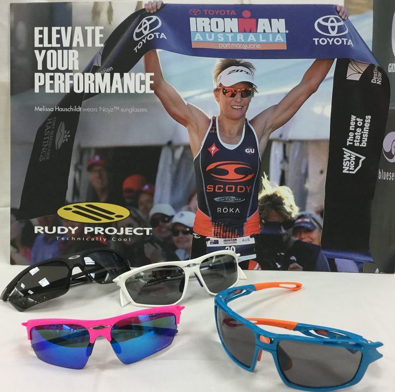 A pair of rudy project sunglasses sit on a table