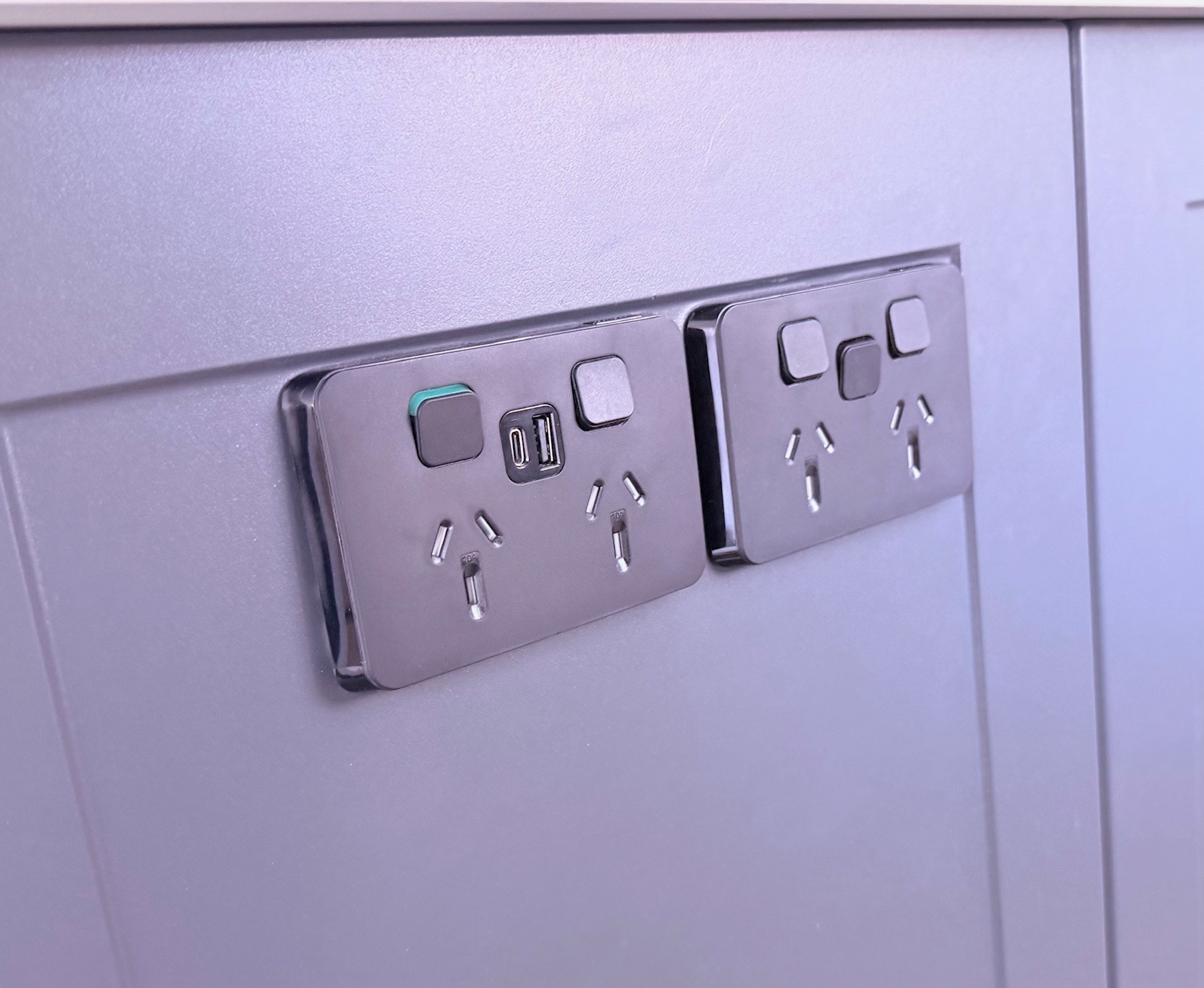 Electrical outlet components removed from a wall, revealing wires.