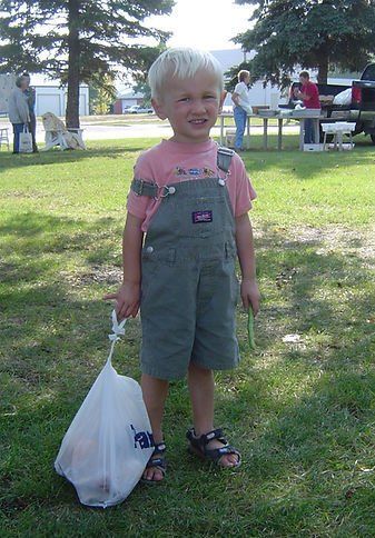 little boy smiling at farmers market