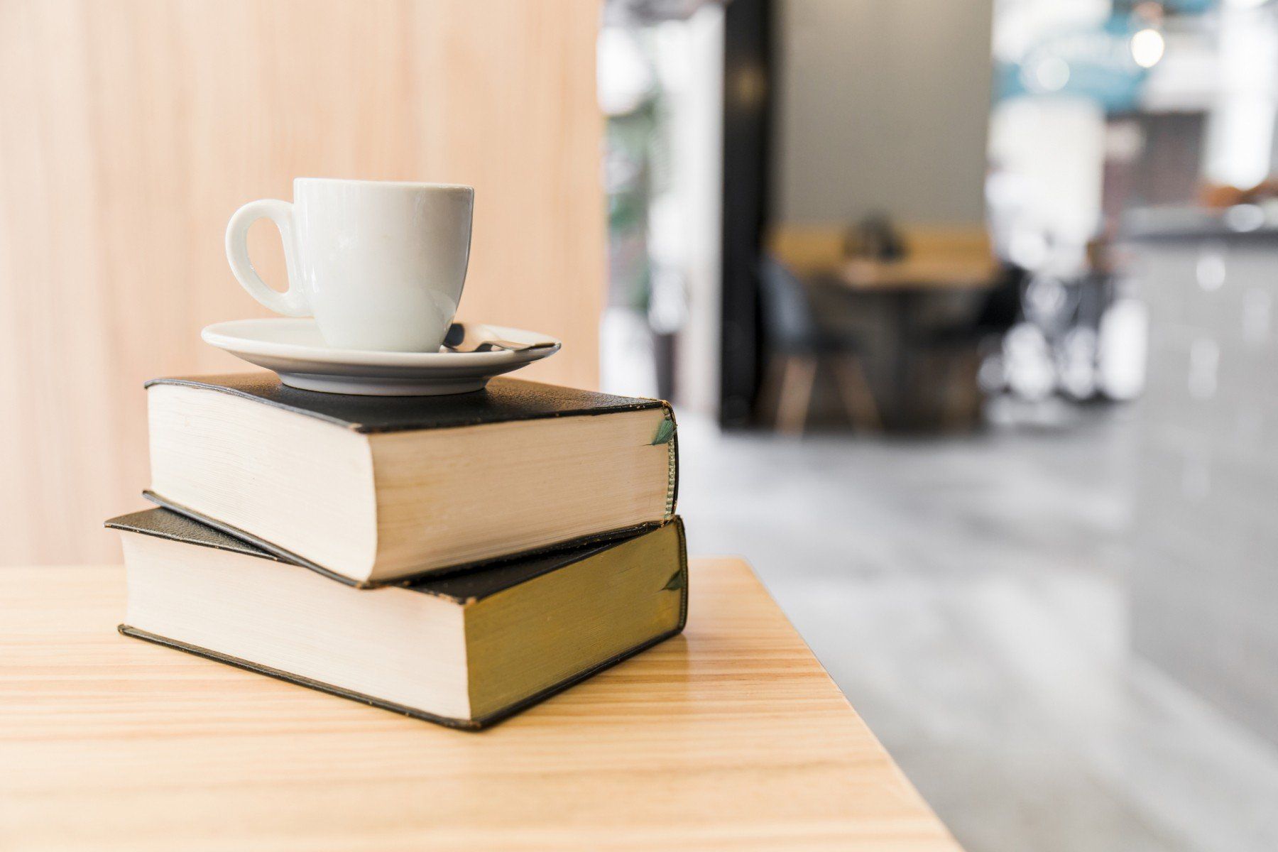 Cup of coffee on top of books