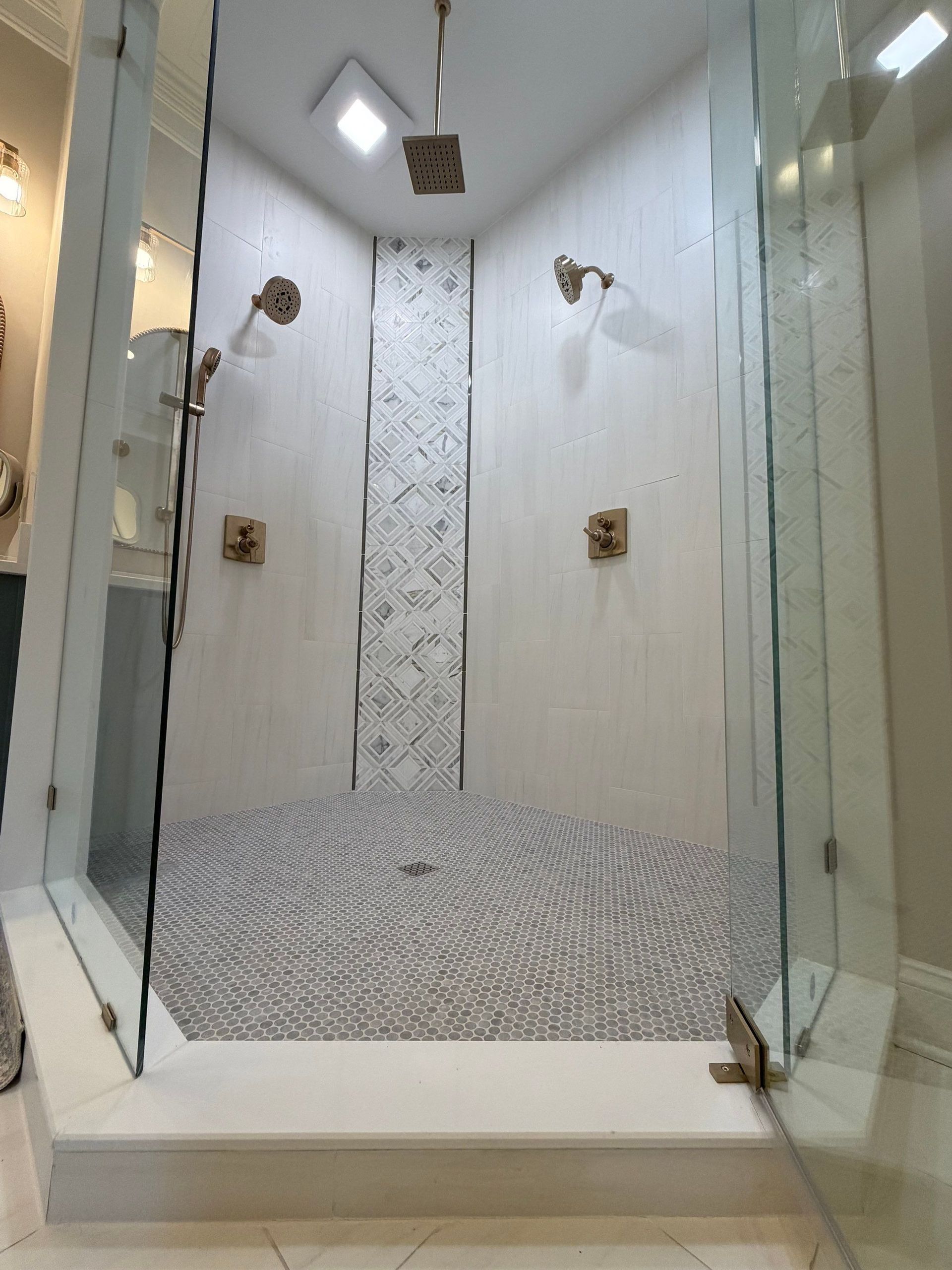 Fully custom glass shower enclosure with new tiling, lighting, and hardware in Franklin, TN