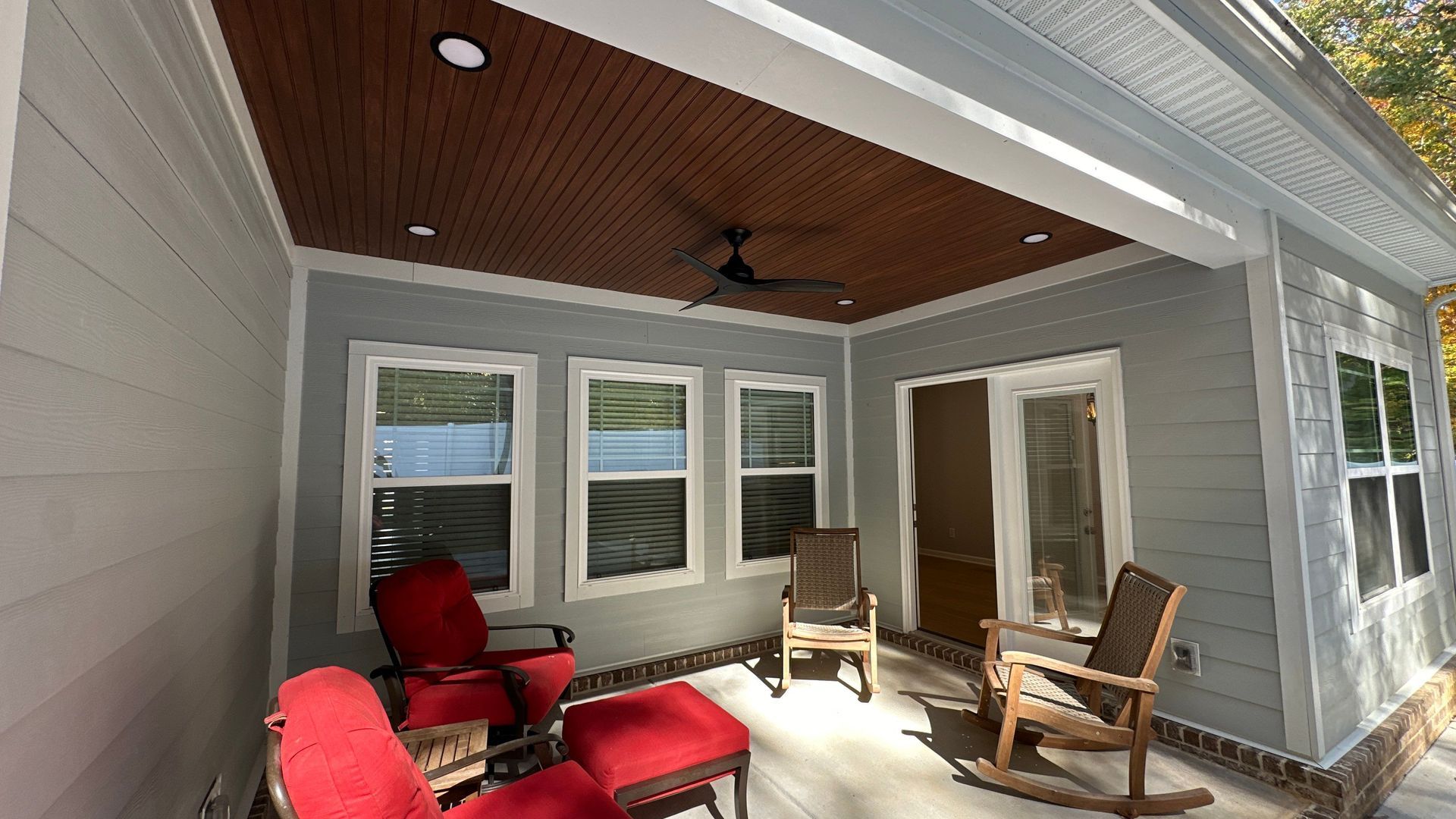 After photo of a Farview porch with new lighting, fan and ceiling treatment