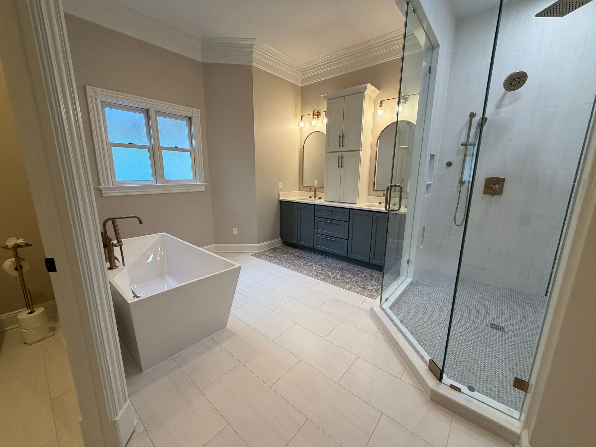 Freestanding tub, custom two-tone vanity and cabinet installation and glass shower enclosure in Franklin TN