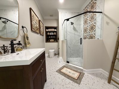 Custom vanity, new tile, and glass shower inclosure accentuate the new layout of this Brentwood, Tennessee bathroom