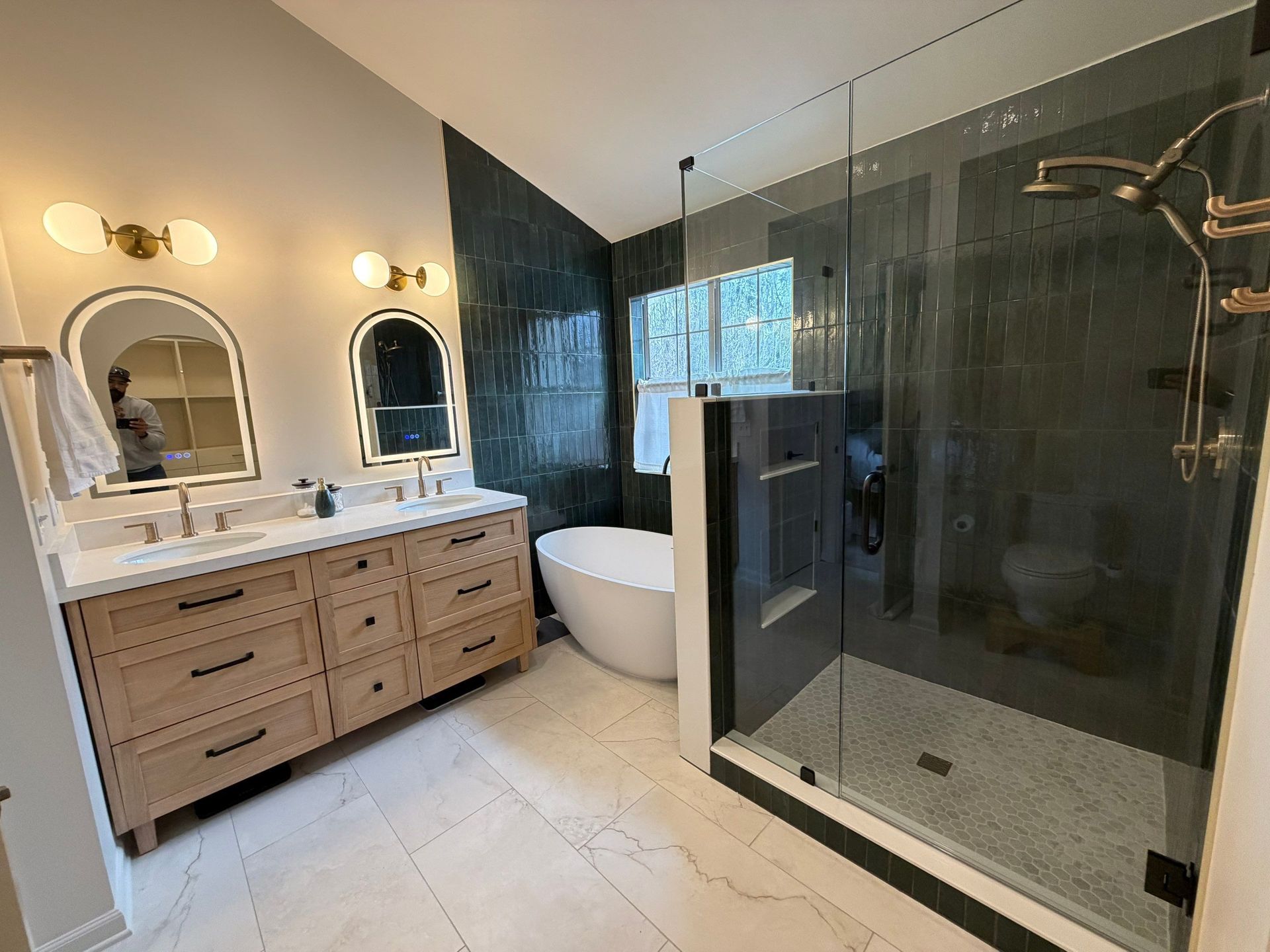 Modern bathroom with double vanity, soaking tub, and glass walk-in shower