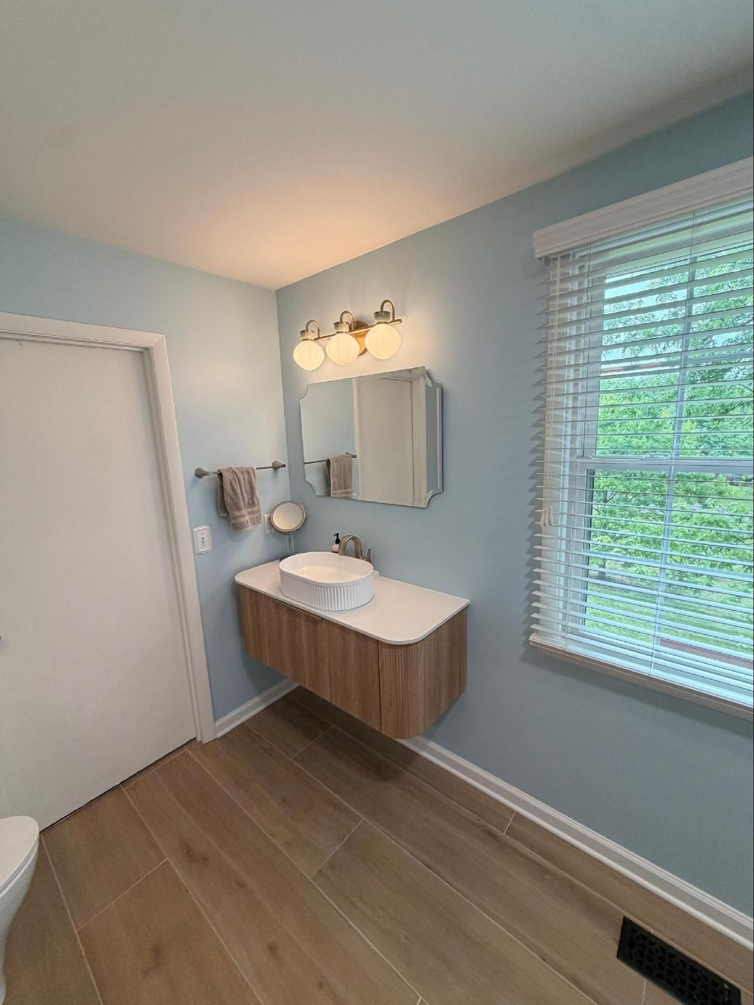 Floating sink and vanity with enhanced lighting after a bathroom renovation in Nashville, TN