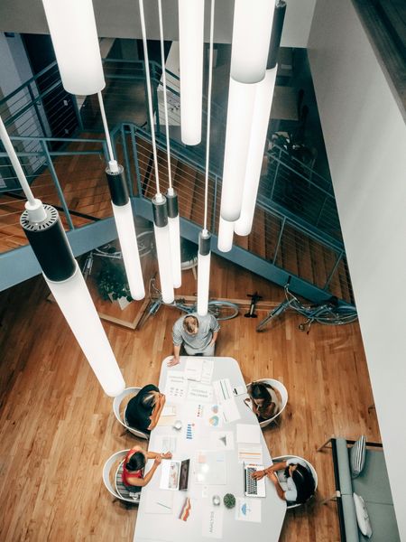 A group of people are sitting around a table in a conference room.