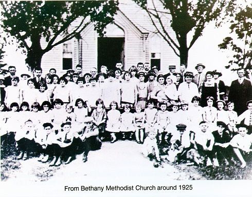A large group of people posing in front of the Bethany Methodist Church, circa 1925.