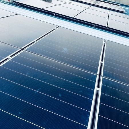 A Row of Solar Panels on the Roof of a Building — Solarblu Pty Ltd in Kangaroo Valley, NSW