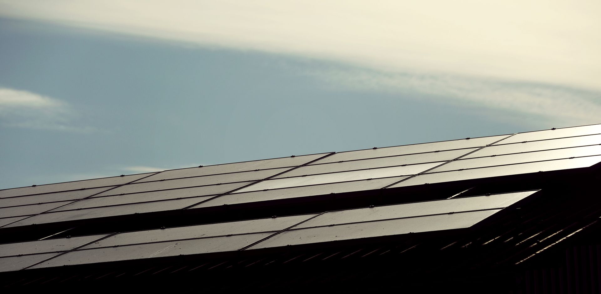 A White House With Solar Panels On The Roof — Solarblu Pty Ltd In Dapto, NSW