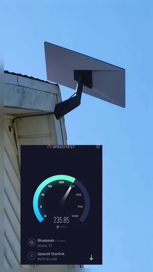 Rooftop satellite dish above a speed test screen showing 23.58 Mbps download speed
