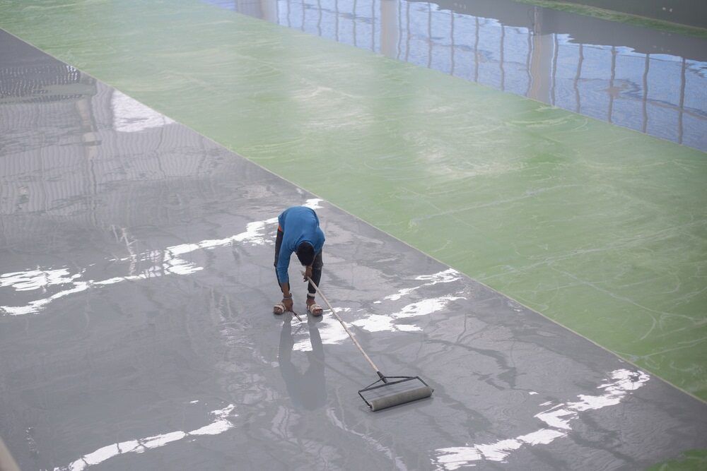 A Man is Cleaning the Floor of a Building With a Broom  — NHM Painting & Projects in Ciccone, NT