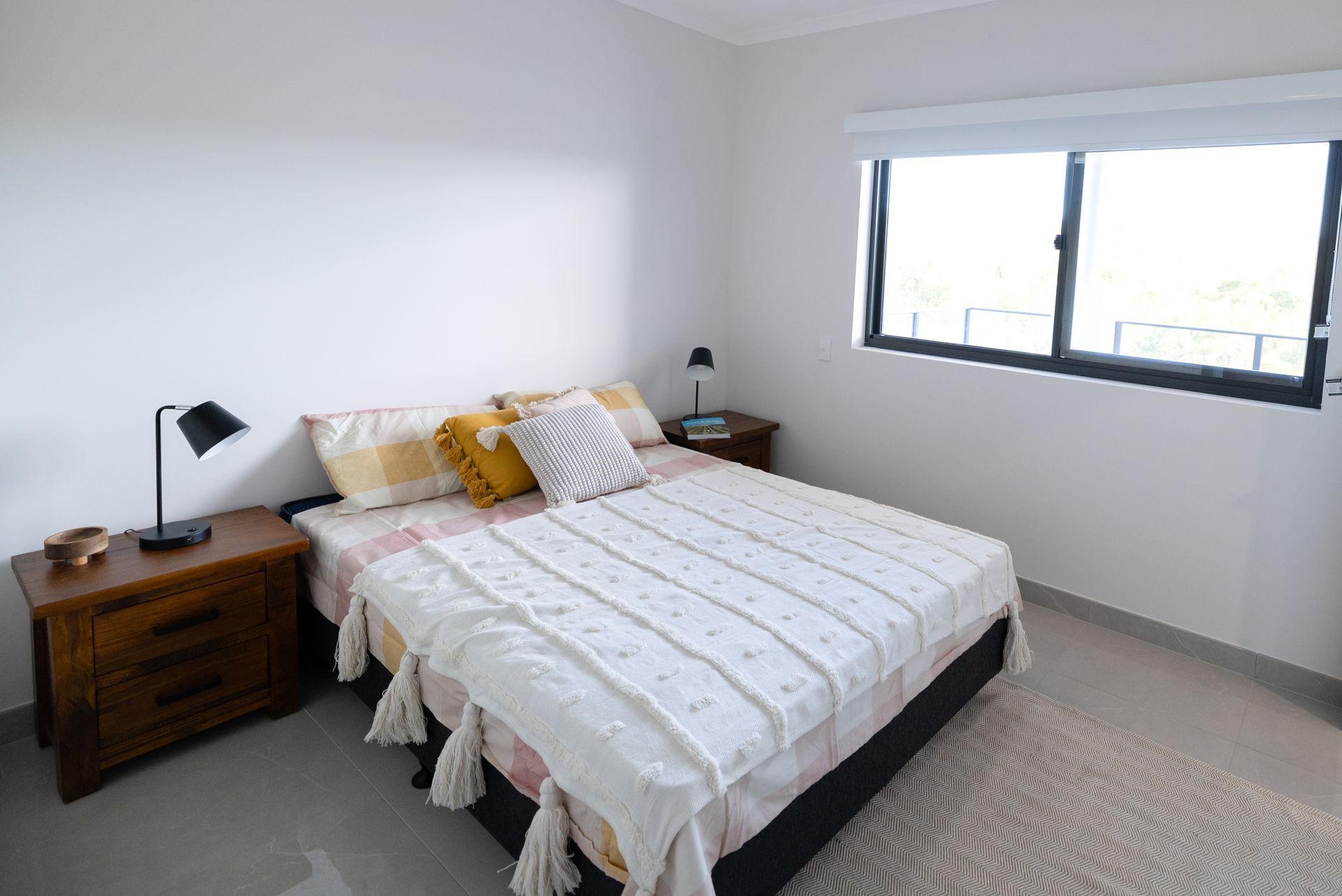 A Bedroom With a Bed, Nightstand, Lamp and Window  — NHM Painting & Projects in Ciccone, NT