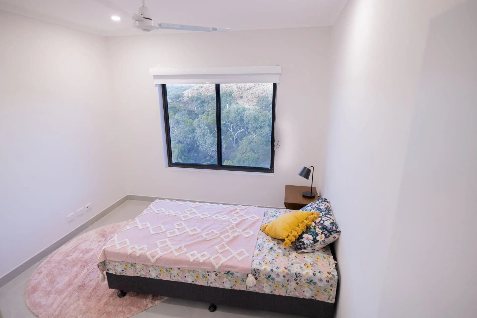 A Bedroom With a Bed and a Window With a Ceiling Fan  — NHM Painting & Projects in Ciccone, NT