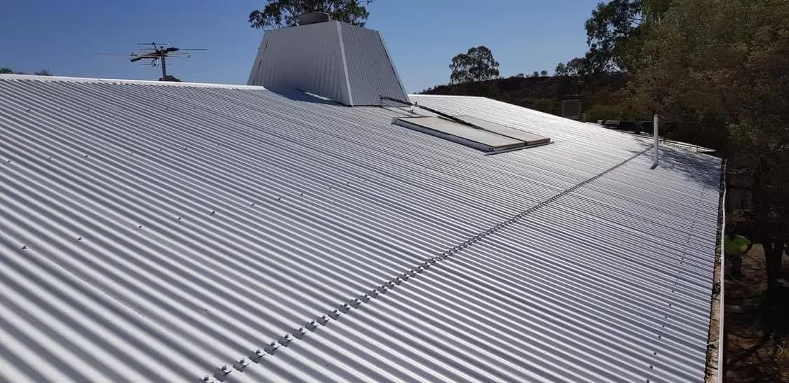 A White Corrugated Metal Roof With a Skylight on Top of It  — NHM Painting & Projects in Ciccone, NT