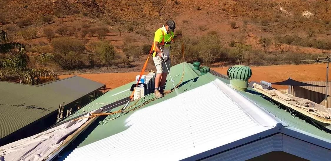 A Man is Standing on the Roof of a House  — NHM Painting & Projects in Ciccone, NT