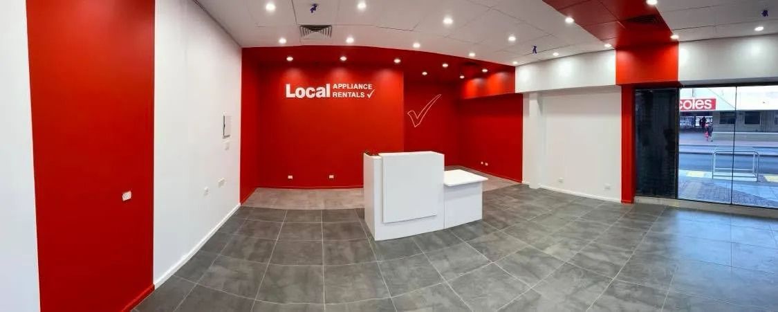 A Large Empty Room With Red Walls and a White Counter  — NHM Painting & Projects in Ciccone, NT